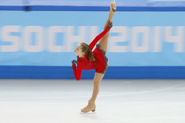 Beautiful figure skater performs a trick