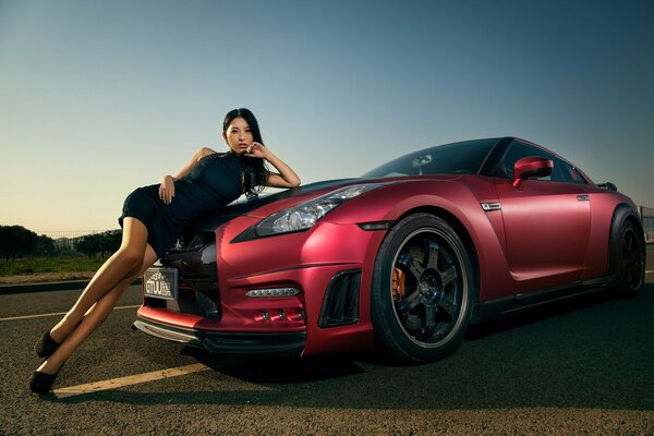 A girl and a Nissan gt-r car