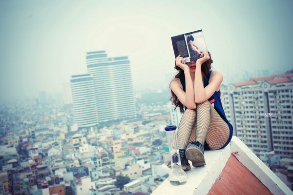 A girl with a book on the roof