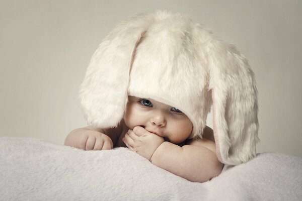 A small child in a bunny hat with ears