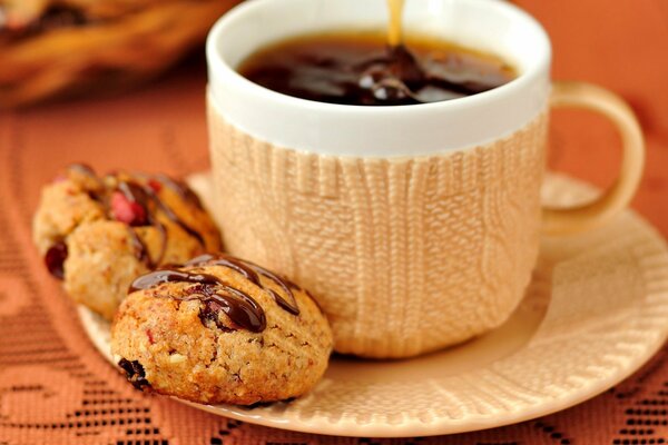 A cup of tea with chocolate cookies