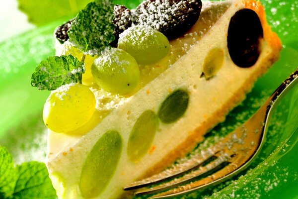 A piece of dessert cake with grapes