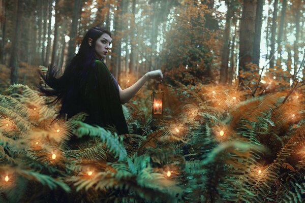 Fille avec une lanterne dans la forêt avec des lucioles