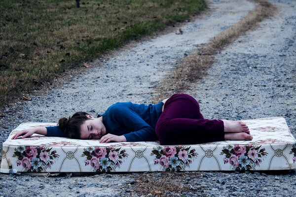 A girl lying on the road