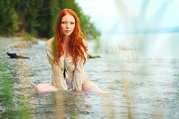 A cute girl is bathing in the river. Nature