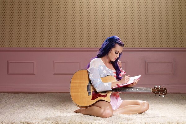 Singer Katy Perry writes in a notebook