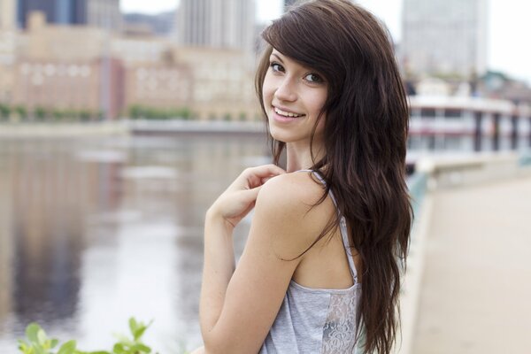 Girl with chocolate hair on the background of the city