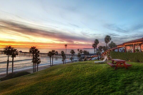 A house on the seashore against the background of a bright evening landscape