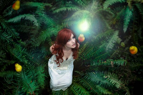 A girl in a fern sees a pear with a light