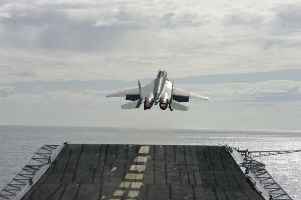 Take-off of a mig-29 cube aircraft from an aircraft carrier, against the sky