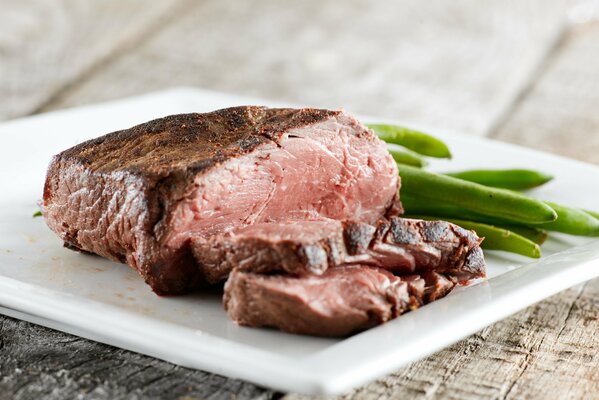 Beef steak with green beans on a plate