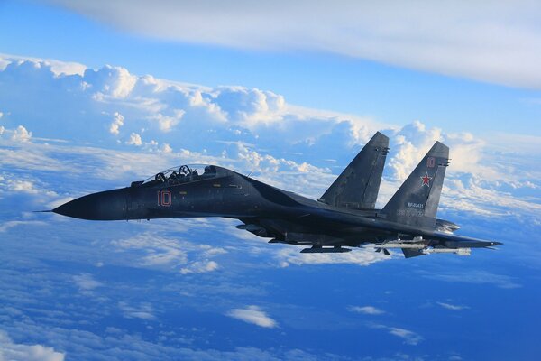 Jet Su-35 in flight against the sky