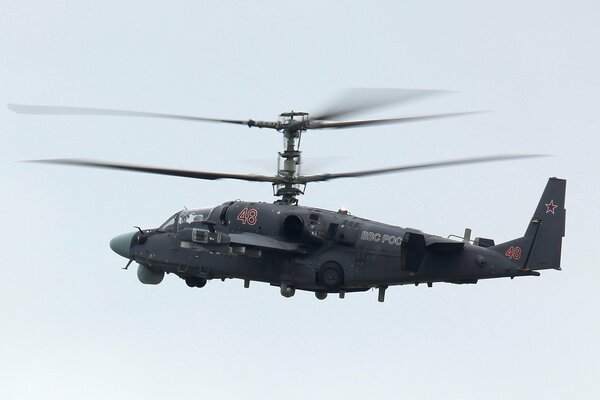 Dark gray alligator helicopter in flight