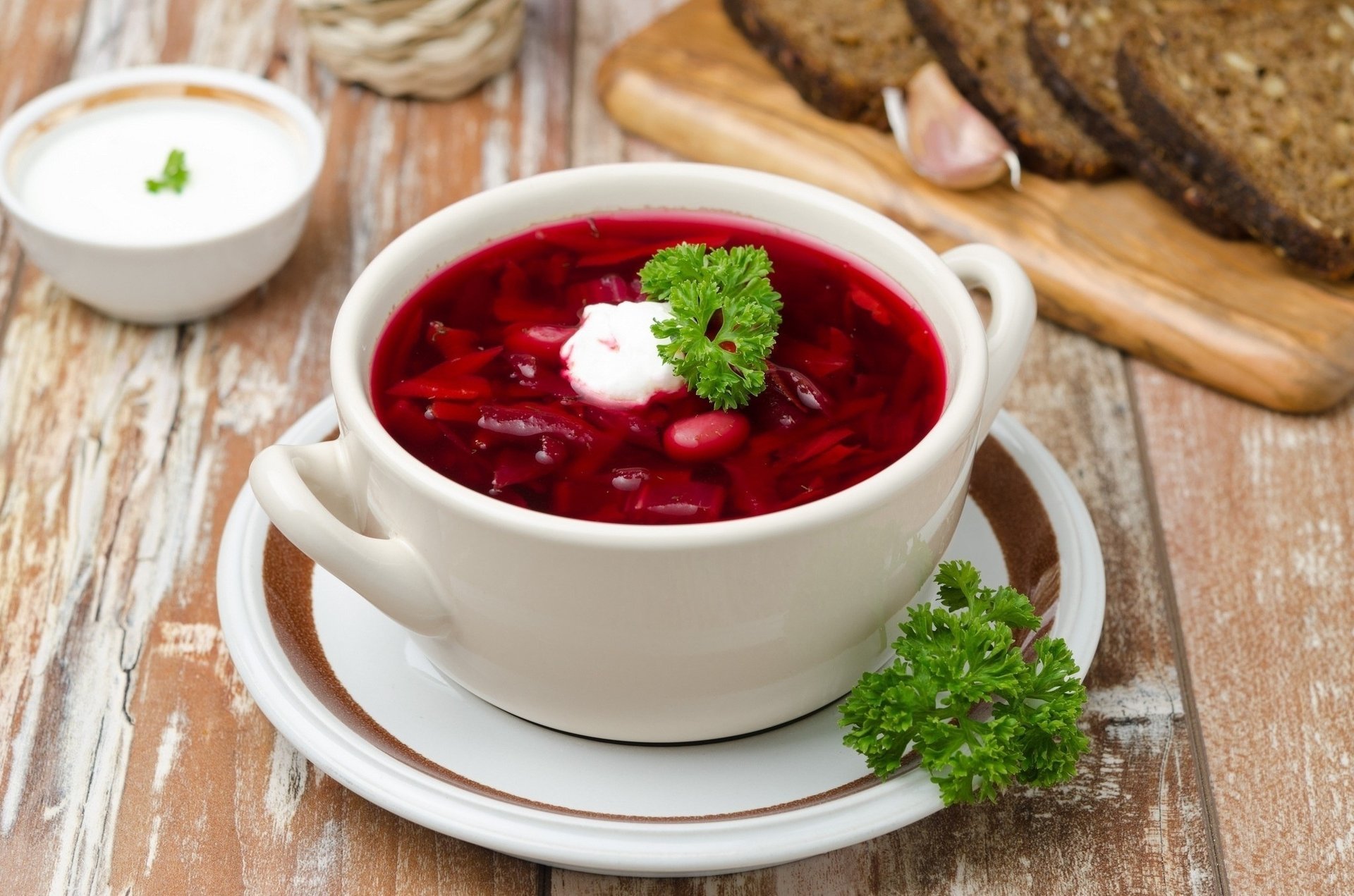 food soup lunch borscht sour cream greens beans bread