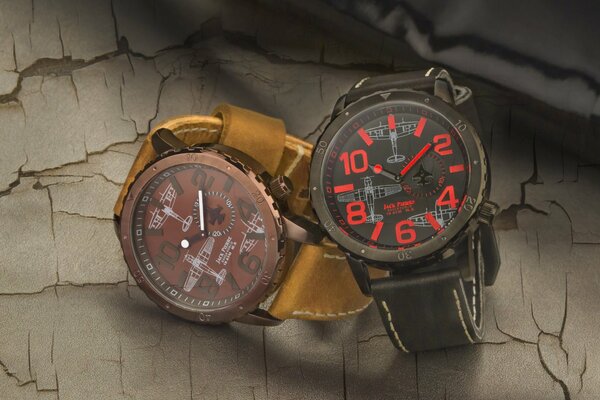 Two wristwatches are depicted on a beige background