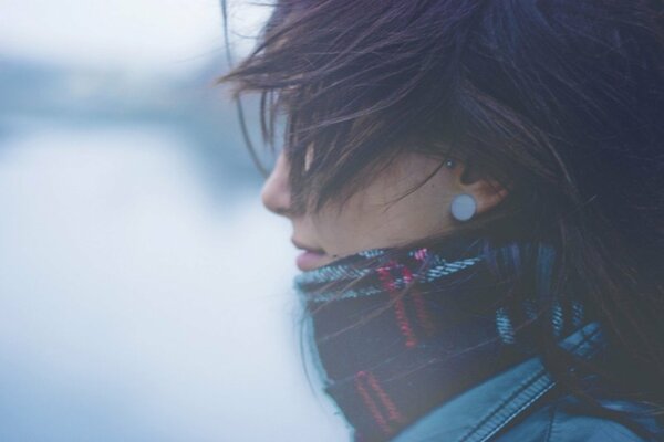 A girl in a scarf with disheveled hair