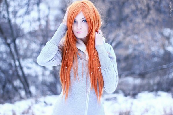 Red-haired girl in nature in winter