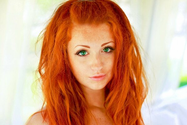 A red-haired beauty with stunning green eyes