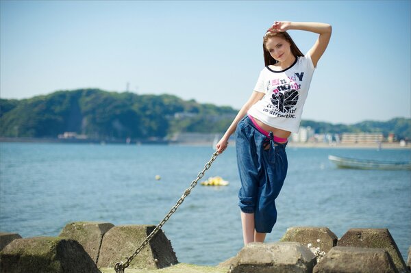 The girl is standing on the seashore