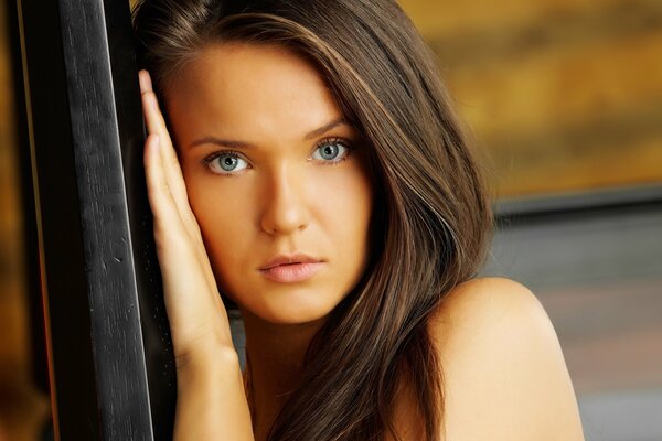 Large portrait of a brown-haired woman with blue eyes