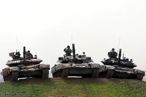 Three tanks in a row stand on the mountain