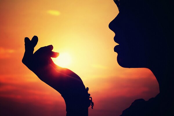 Silueta de una niña en el fondo de una puesta de sol