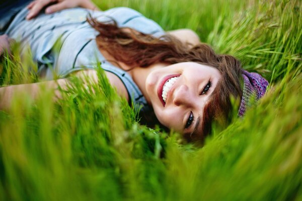 The smile of a girl on the grass