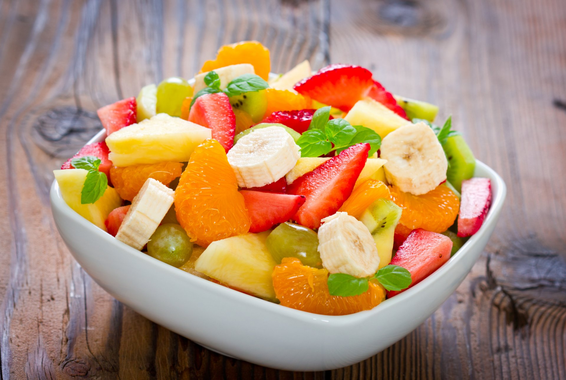 dessert fruit salad banana mandarin strawberry pineapple mint leaves mandarin orange