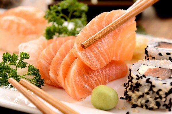 Japanese-style fish and sushi dish with chopsticks