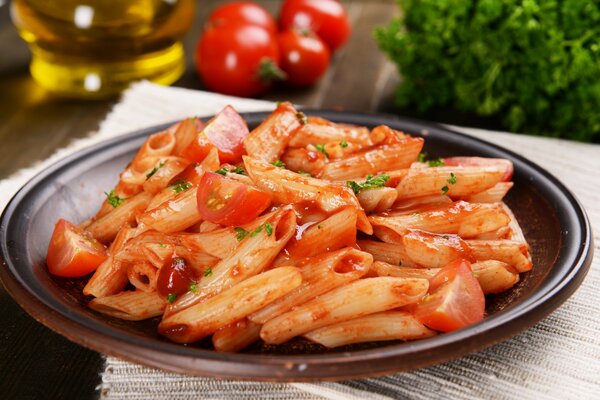 Pasta with mushrooms on a plate in tomato sauce