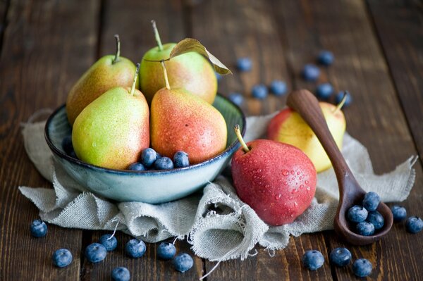 Table with a plate of pears and berries