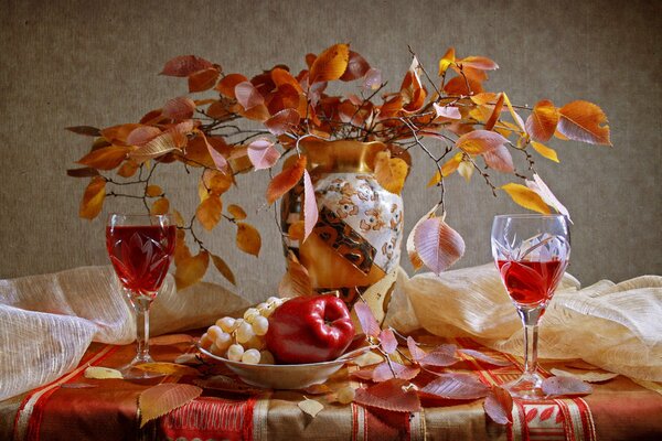 Still life yellow leaves, wine glasses and fruit