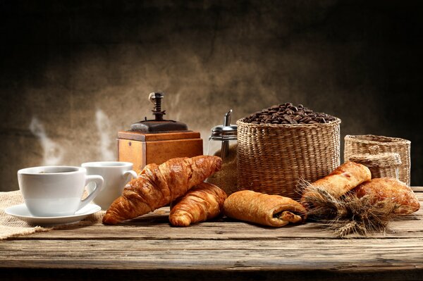 Fresh bread to the table with a cup of coffee made in a coffee grinder