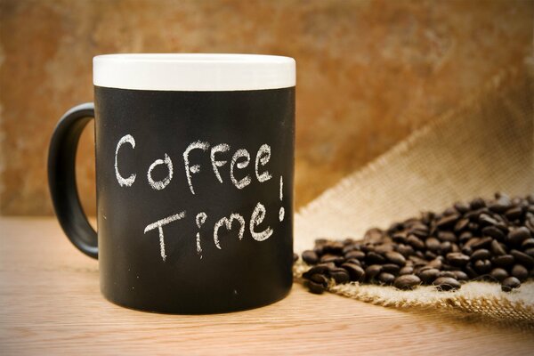 Black and white mug and coffee beans