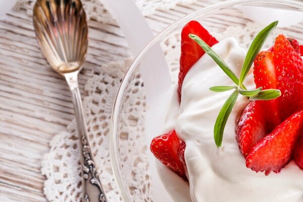 Cream dessert and a spoon in the form of a shell