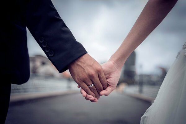 Husband and bride holding hands