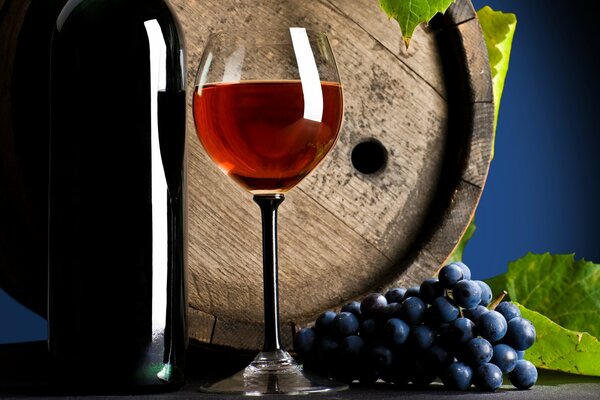A glass of wine on the background of a wooden barrel