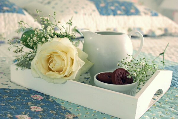 Breakfast in bed - tea and sweet biscuits, complemented with flowers