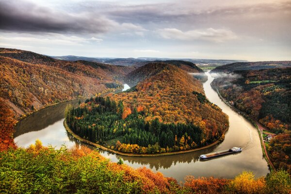 Die Biegung des Flusses inmitten des Waldes im Herbst