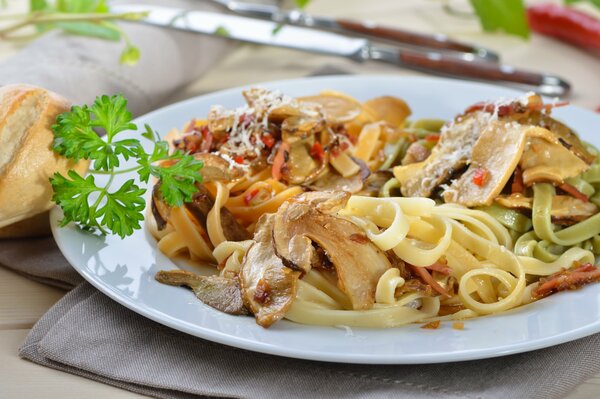 Pasta with vegetables and herbs on a plate