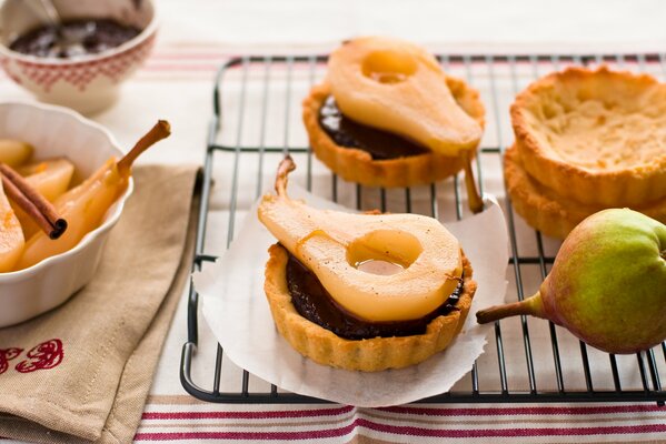 Tartlets with pears on a baking sheet