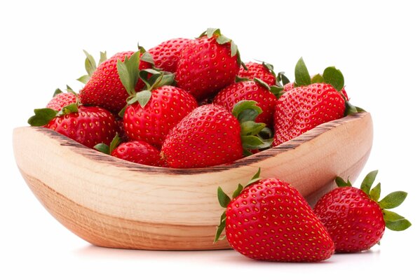 Juicy strawberries in a wooden bowl