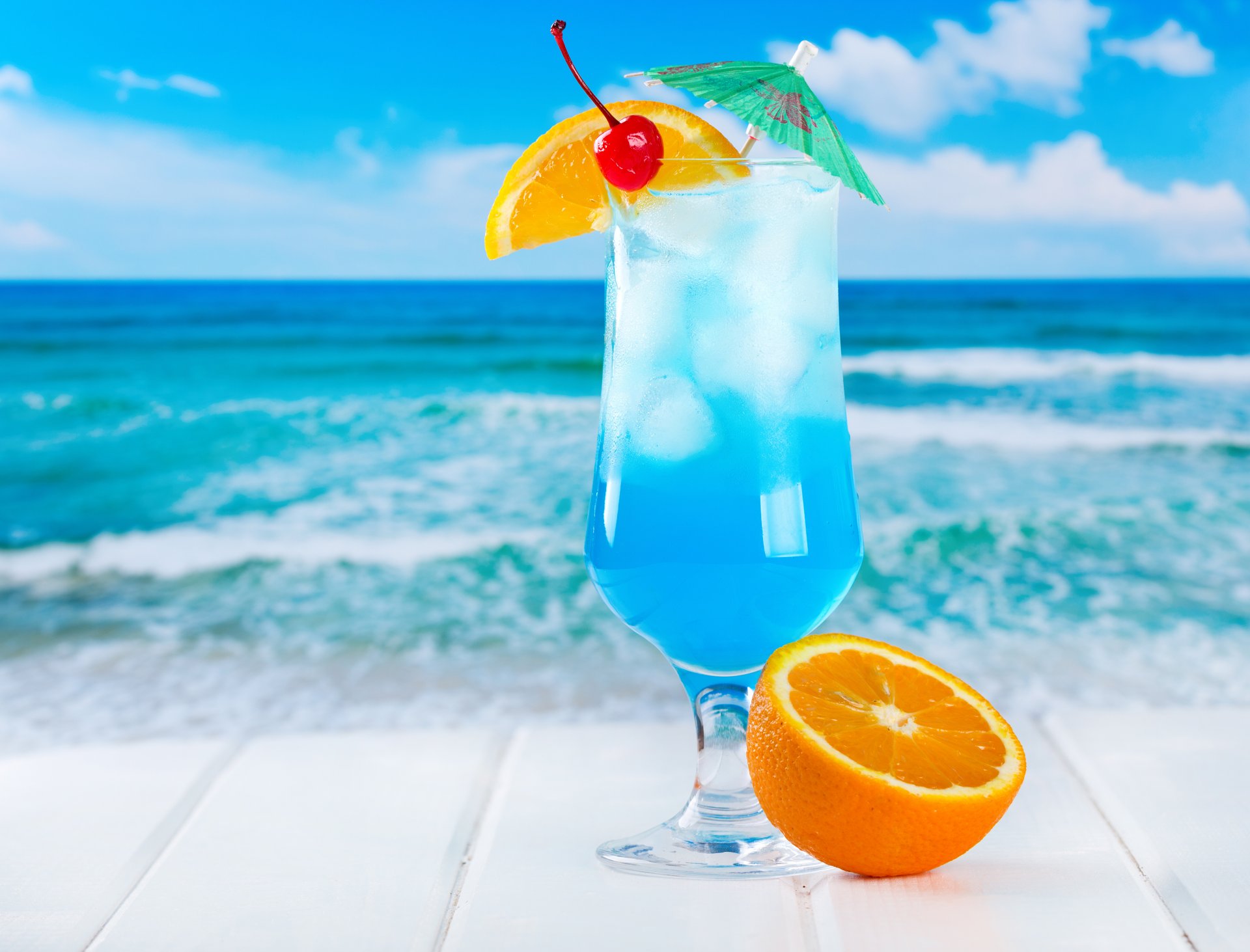 tropical cocktail blue orange drink fruit fresh sea ice beach