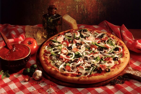 Italian cuisine - pizza with tomatoes, olives, sausage, bell pepper, olives