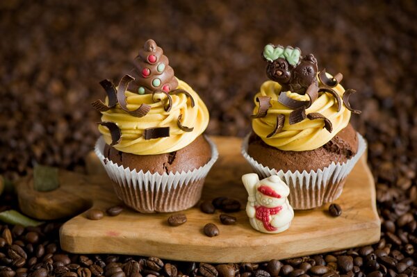 Delicious cupcakes with cream on a board