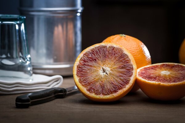 Still life with citrus fruits, knife and glass