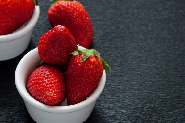 Red strawberries in a bowl on the table