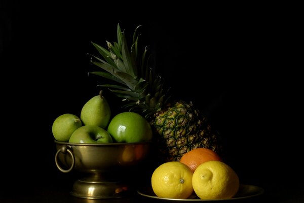 Still life with pineapple, apples, lemons and orange