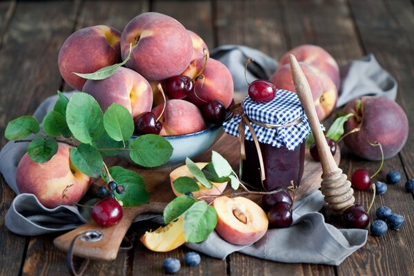 Still life of peaches and berries. Fruit on the table