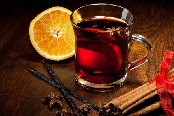 Mug of mulled wine on the background of spices